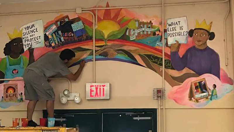 a school mural being installed